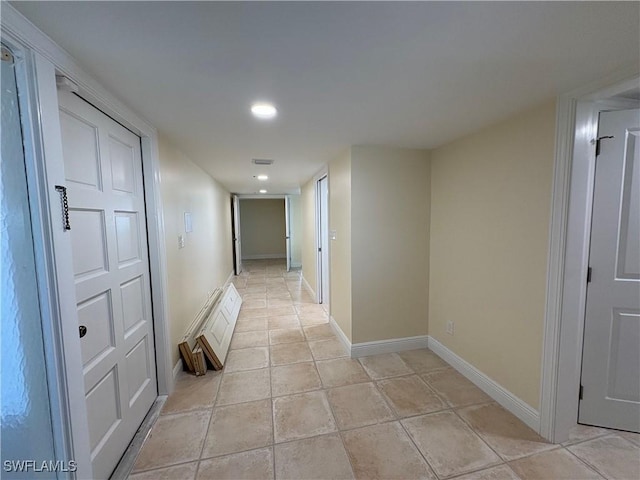 corridor featuring light tile patterned floors