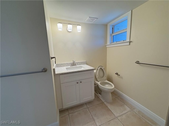 bathroom with tile patterned floors, vanity, and toilet