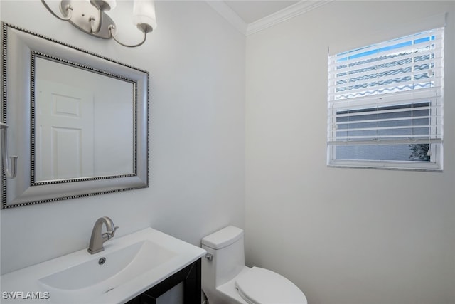 bathroom featuring crown molding, toilet, and sink