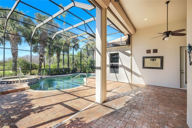 view of pool featuring a lanai, a patio area, ceiling fan, and an in ground hot tub