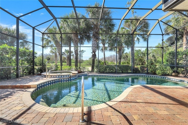 view of pool with an in ground hot tub, a lanai, and a patio