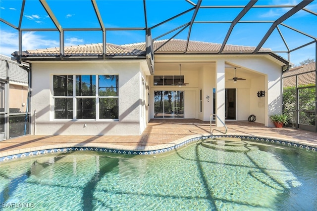 back of house with ceiling fan, a patio, and glass enclosure