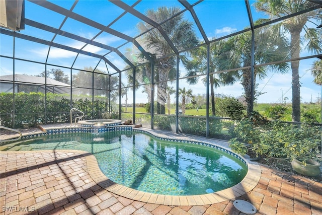 view of pool with an in ground hot tub, a lanai, and a patio