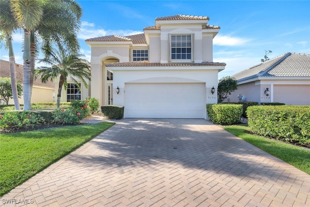 mediterranean / spanish house with a garage