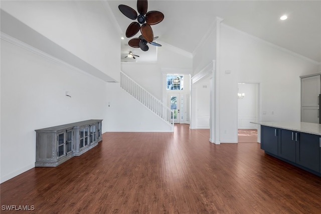 unfurnished living room featuring dark wood-type flooring, ceiling fan, ornamental molding, and high vaulted ceiling