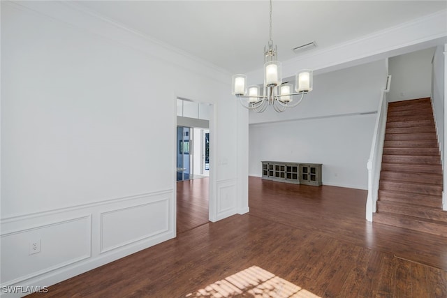 unfurnished room featuring crown molding, a notable chandelier, and dark hardwood / wood-style flooring