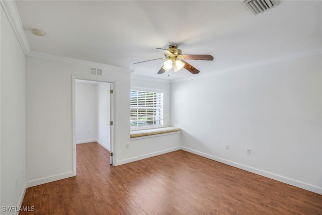 spare room featuring hardwood / wood-style flooring, crown molding, and ceiling fan