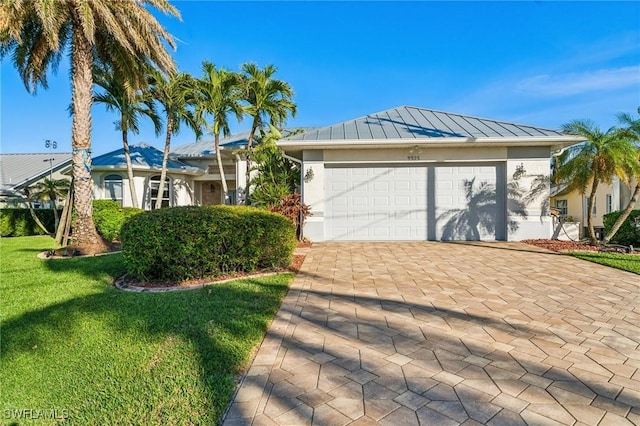 ranch-style home with a garage and a front yard