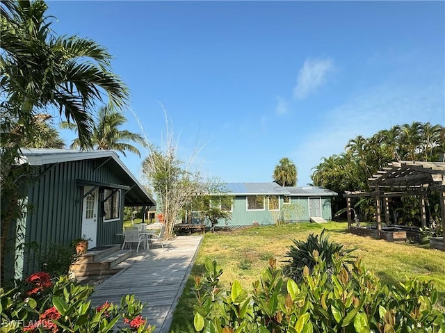 view of yard with a wooden deck, an outdoor structure, and a pergola