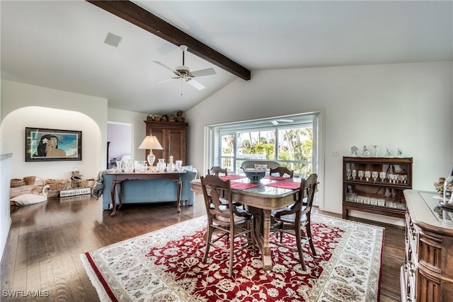 dining room with dark hardwood / wood-style flooring, vaulted ceiling with beams, and ceiling fan