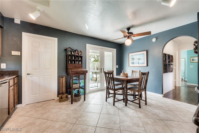 dining space with light tile patterned floors, ceiling fan, and french doors