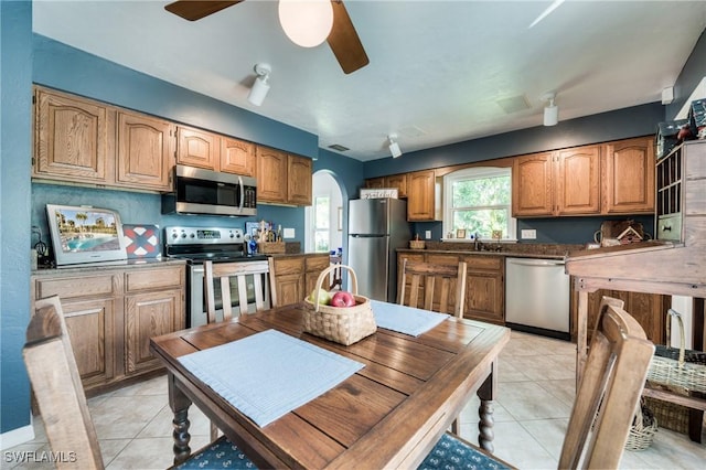 kitchen featuring sink, stainless steel appliances, ceiling fan, and light tile patterned flooring