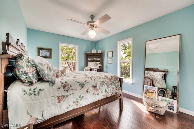 bedroom with ceiling fan, hardwood / wood-style floors, and multiple windows