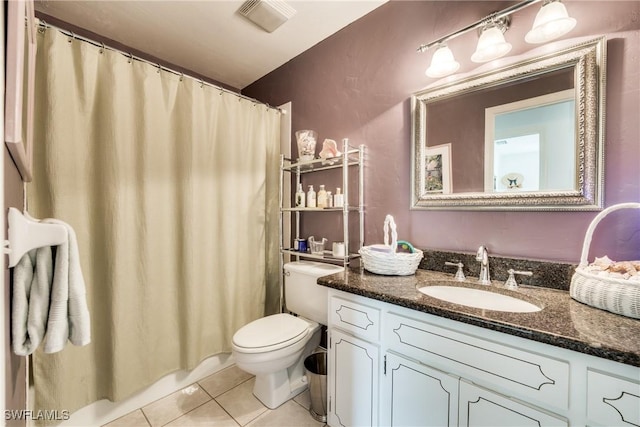 bathroom featuring tile patterned floors, toilet, and vanity