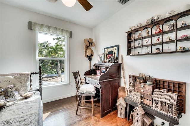 home office with wood-type flooring and ceiling fan