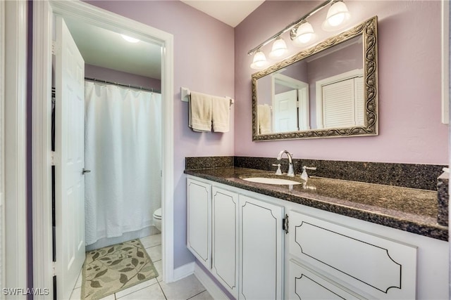 bathroom featuring tile patterned floors, toilet, and vanity