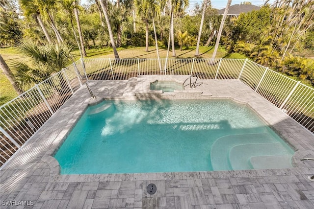 view of pool with an in ground hot tub, a yard, and a patio area