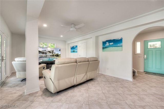 living room featuring light tile patterned floors and ceiling fan