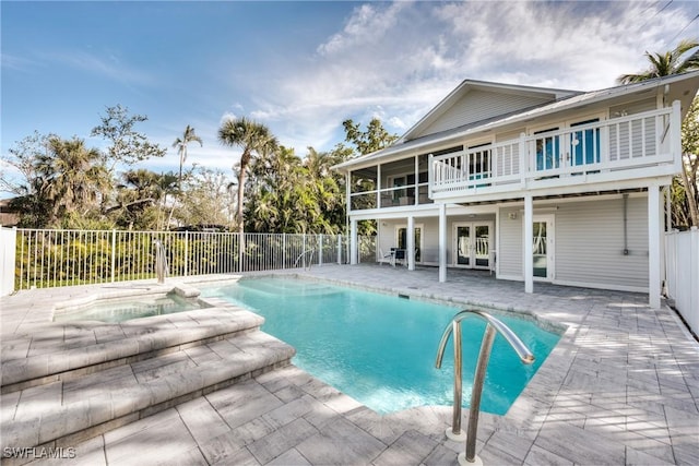 view of pool with french doors and a patio area