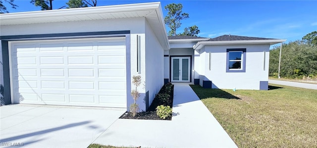 ranch-style house with a garage, a front yard, and french doors