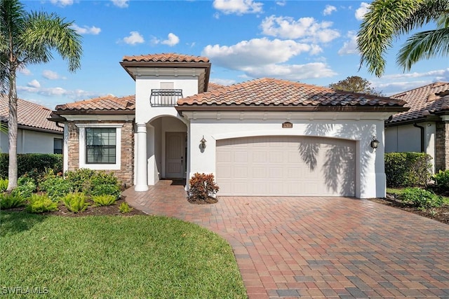 mediterranean / spanish-style house featuring a balcony, a garage, and a front lawn