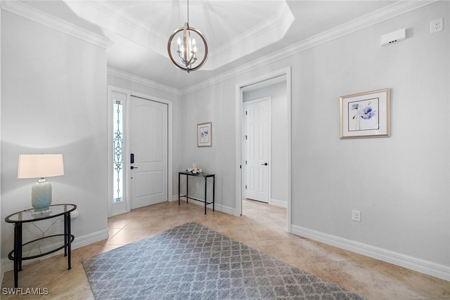 tiled entryway featuring an inviting chandelier, a tray ceiling, and crown molding