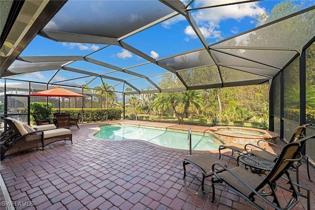 view of swimming pool featuring an in ground hot tub, a lanai, and a patio