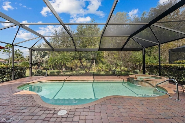 view of swimming pool featuring a lanai, a patio area, and an in ground hot tub