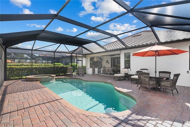 view of pool with an in ground hot tub, glass enclosure, and a patio