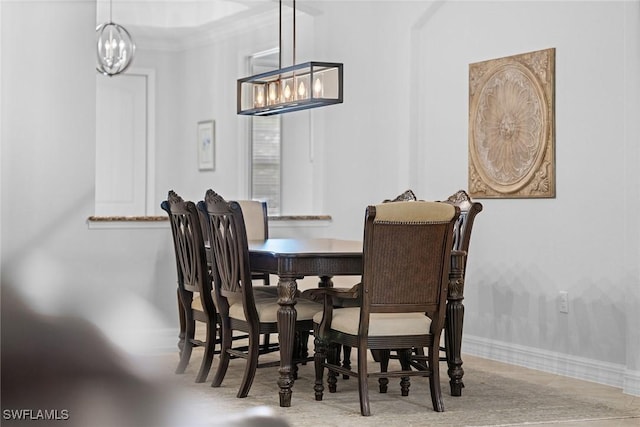 dining area with an inviting chandelier and crown molding