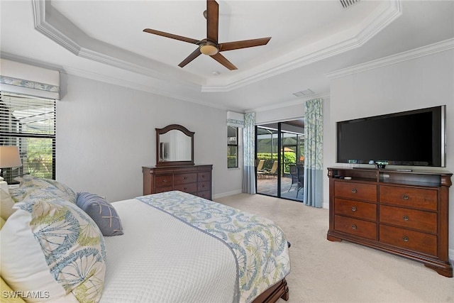 bedroom with light colored carpet, ornamental molding, a raised ceiling, ceiling fan, and access to exterior