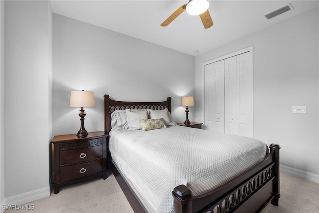 carpeted bedroom with a closet and ceiling fan