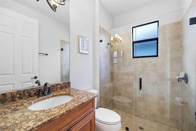 bathroom with vanity, toilet, and an enclosed shower