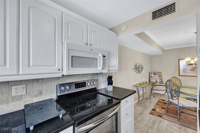 kitchen with stainless steel range with electric stovetop, backsplash, light hardwood / wood-style floors, and white cabinets