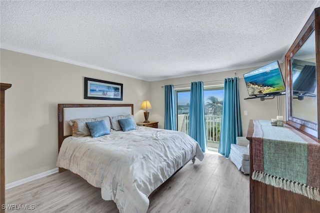 bedroom featuring ornamental molding, light wood-type flooring, a textured ceiling, and access to outside