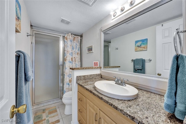 bathroom with tile patterned flooring, vanity, walk in shower, toilet, and a textured ceiling