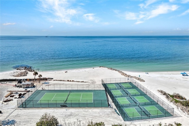 drone / aerial view featuring a water view and a view of the beach