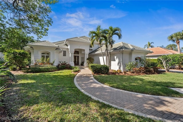 mediterranean / spanish-style house with a front yard