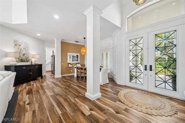 entrance foyer with dark hardwood / wood-style flooring, decorative columns, and french doors