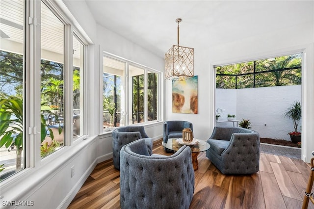 sunroom with an inviting chandelier and a healthy amount of sunlight