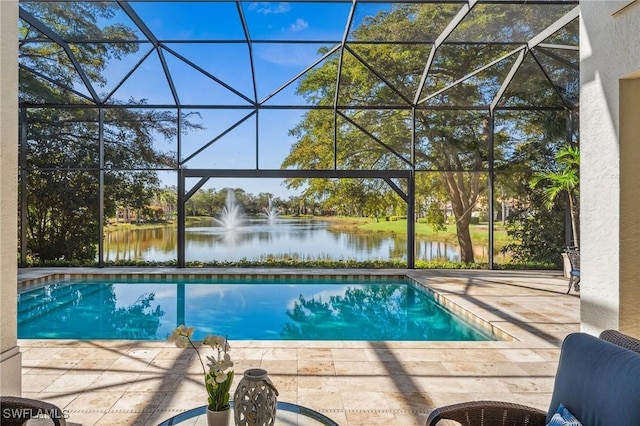 view of swimming pool with a water view and glass enclosure