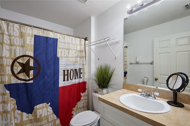 bathroom featuring vanity, an inviting chandelier, and toilet