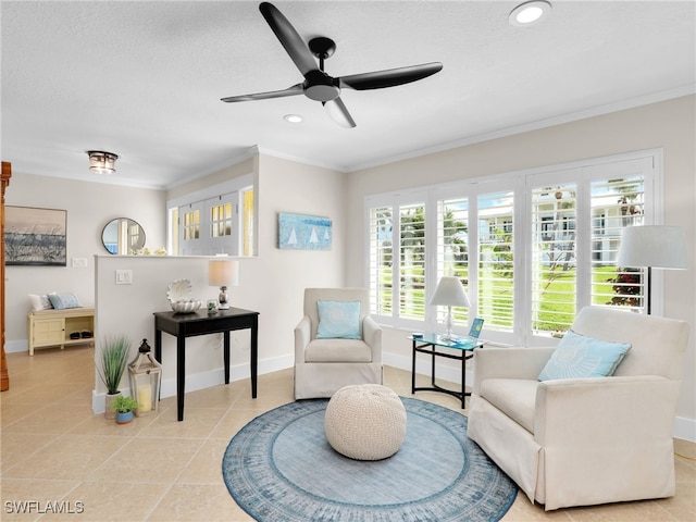 sitting room with light tile patterned floors, ornamental molding, a textured ceiling, and ceiling fan