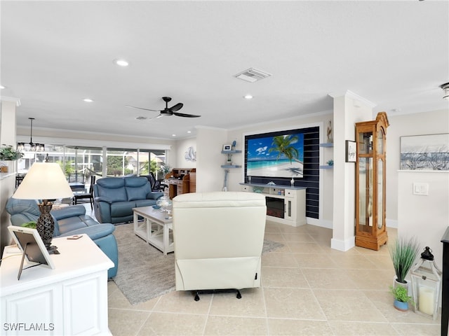 tiled living room featuring crown molding and ceiling fan