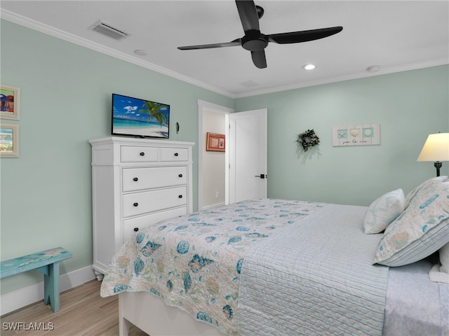 bedroom with crown molding, light hardwood / wood-style flooring, and ceiling fan