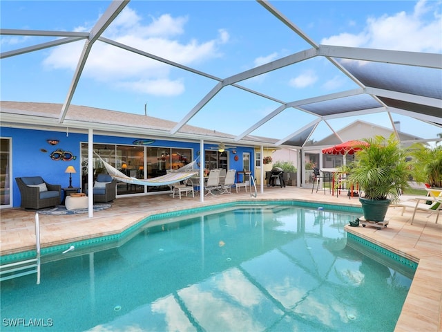 view of swimming pool with a patio area and glass enclosure