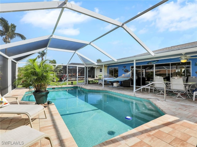 view of swimming pool featuring a lanai and a patio