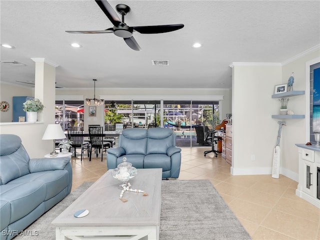 tiled living room with ceiling fan, ornamental molding, and a textured ceiling