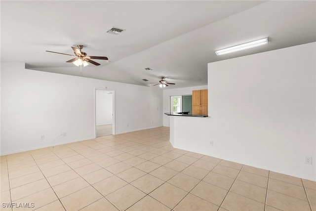 empty room featuring ceiling fan and light tile patterned floors