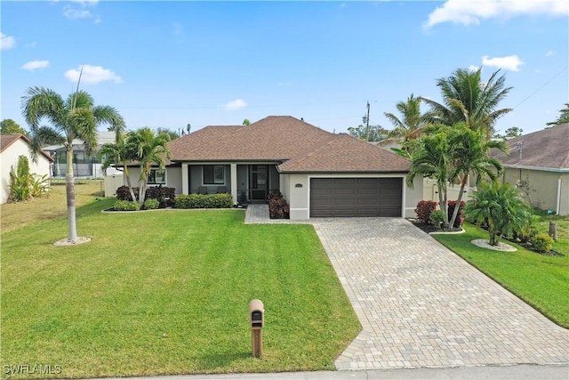 single story home with a garage and a front lawn